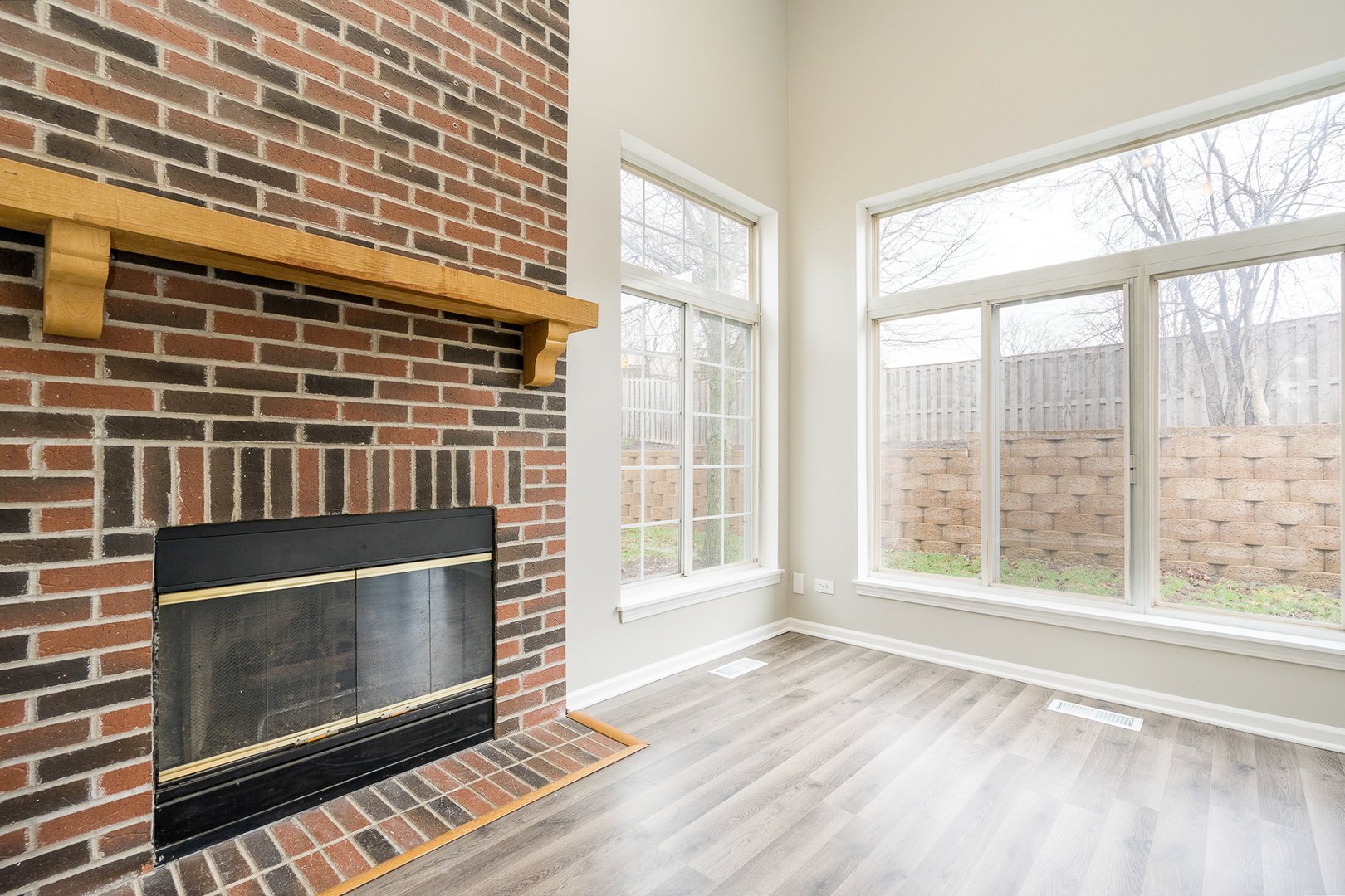 8191 Ripple Ridge Darien, IL 60561 - Photo 7 of 20 a view of an empty room with wooden floor and a window