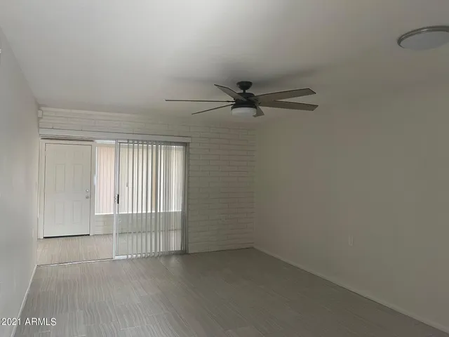 a view of a livingroom with a ceiling fan and window