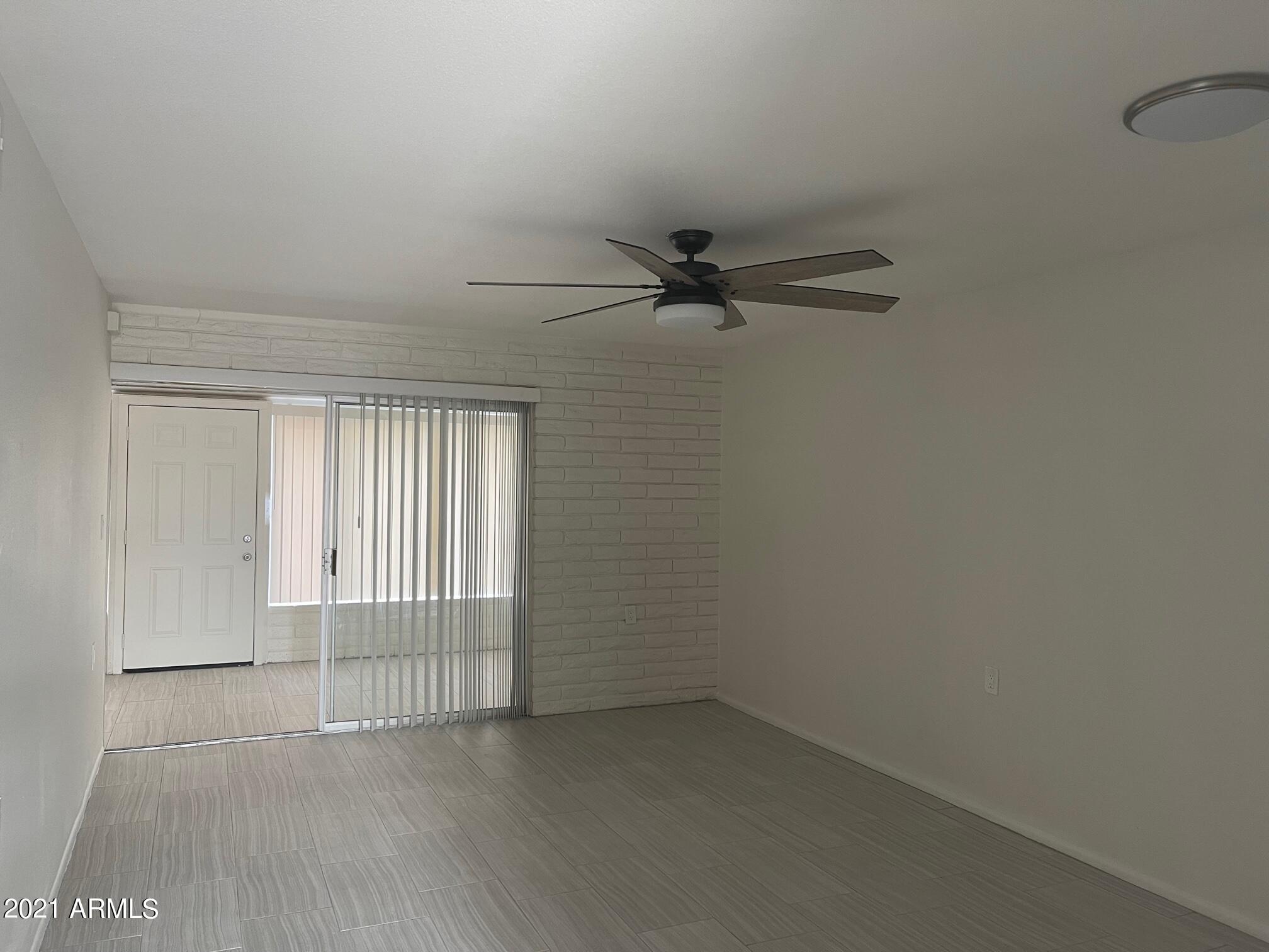 12847 North 113th Avenue, Unit 14 Youngtown, AZ 85363 - Photo 2 of 10 a view of a livingroom with a ceiling fan and window