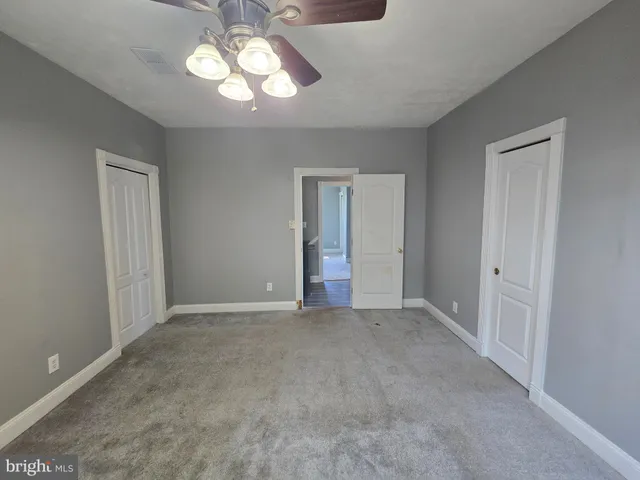 a view of a livingroom with a ceiling fan and window