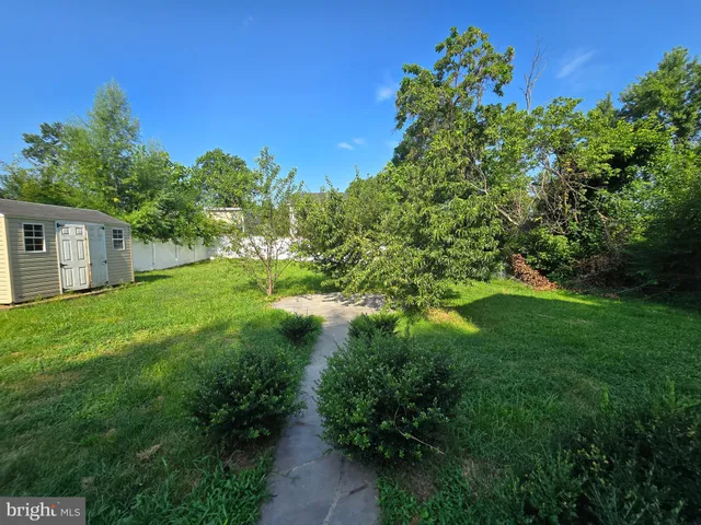 a kitchen with granite countertop a stove top oven microwave and cabinets