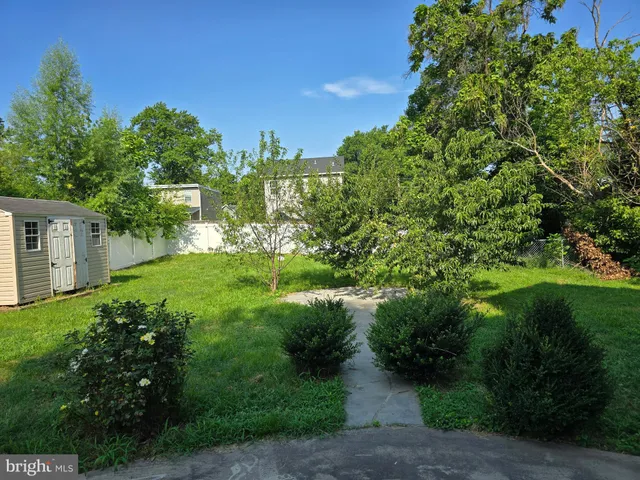 an empty room with window and wooden floor
