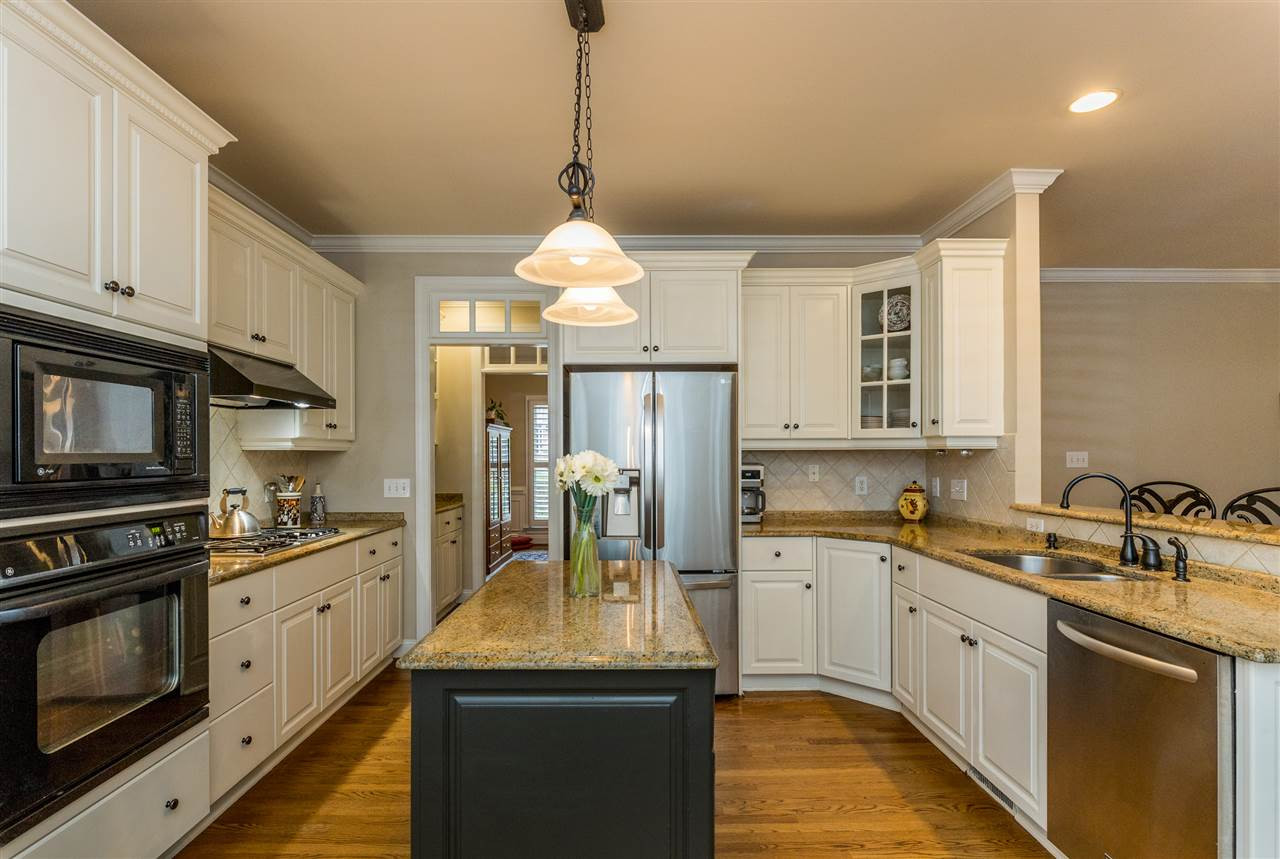 3705 Wesley Ridge Drive Apex, NC 27539 - Photo 6 of 30 Kitchen with center island, gas range, granite countertops. Open to living room and breakfast area. Kitchen