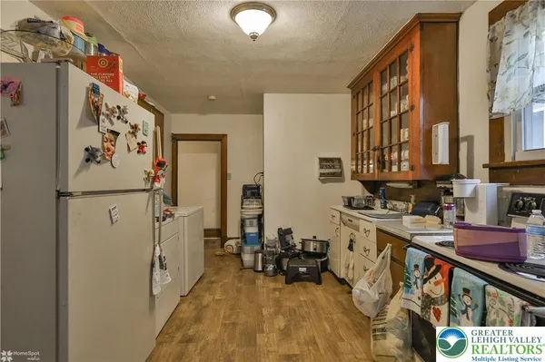 a kitchen with stainless steel appliances granite countertop a refrigerator and a stove