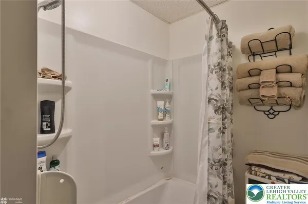a bathroom with a tub and a shower