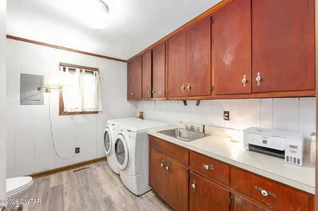 a view of a storage and utility room with washer and dryer