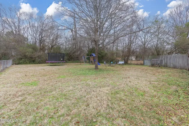 a backyard of apartments with large trees