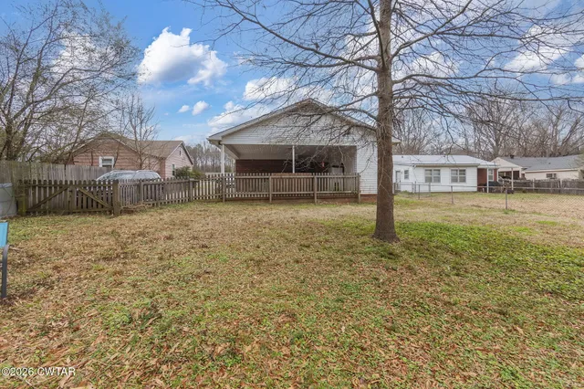 a view of a house with a yard covered in snow