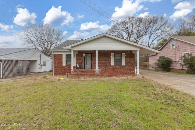 a view of a yard in front view of a house