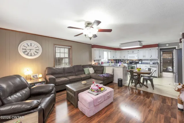 a living room with furniture and kitchen view