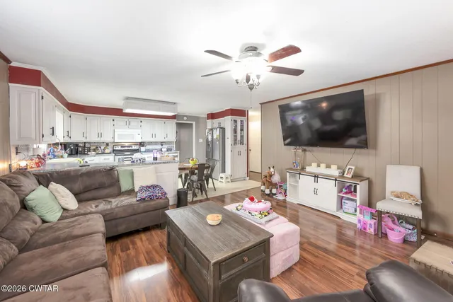 a living room with furniture and a flat screen tv