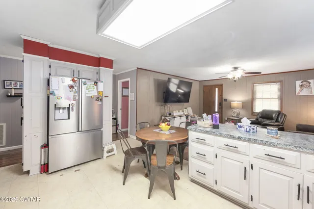 a kitchen with a refrigerator and a sink