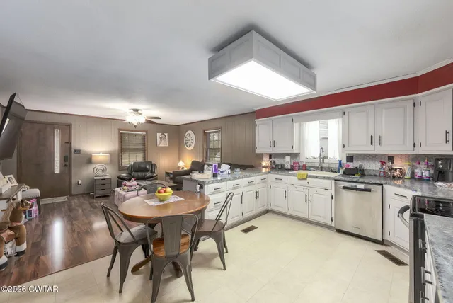 a large kitchen with a table and chairs in it