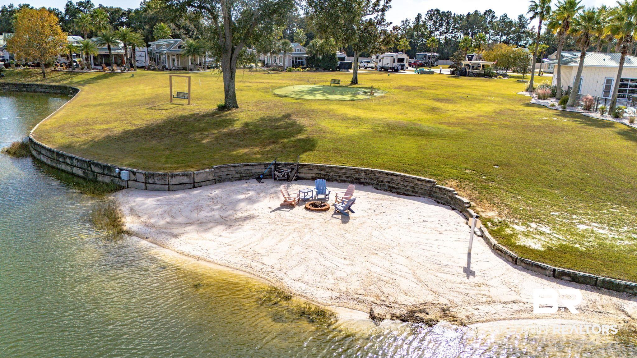 12004 Raptor Court Elberta, AL 36530 - Photo 49 of 57 Surrounding community featuring a water view, a yard, a residential view, and a fire pit