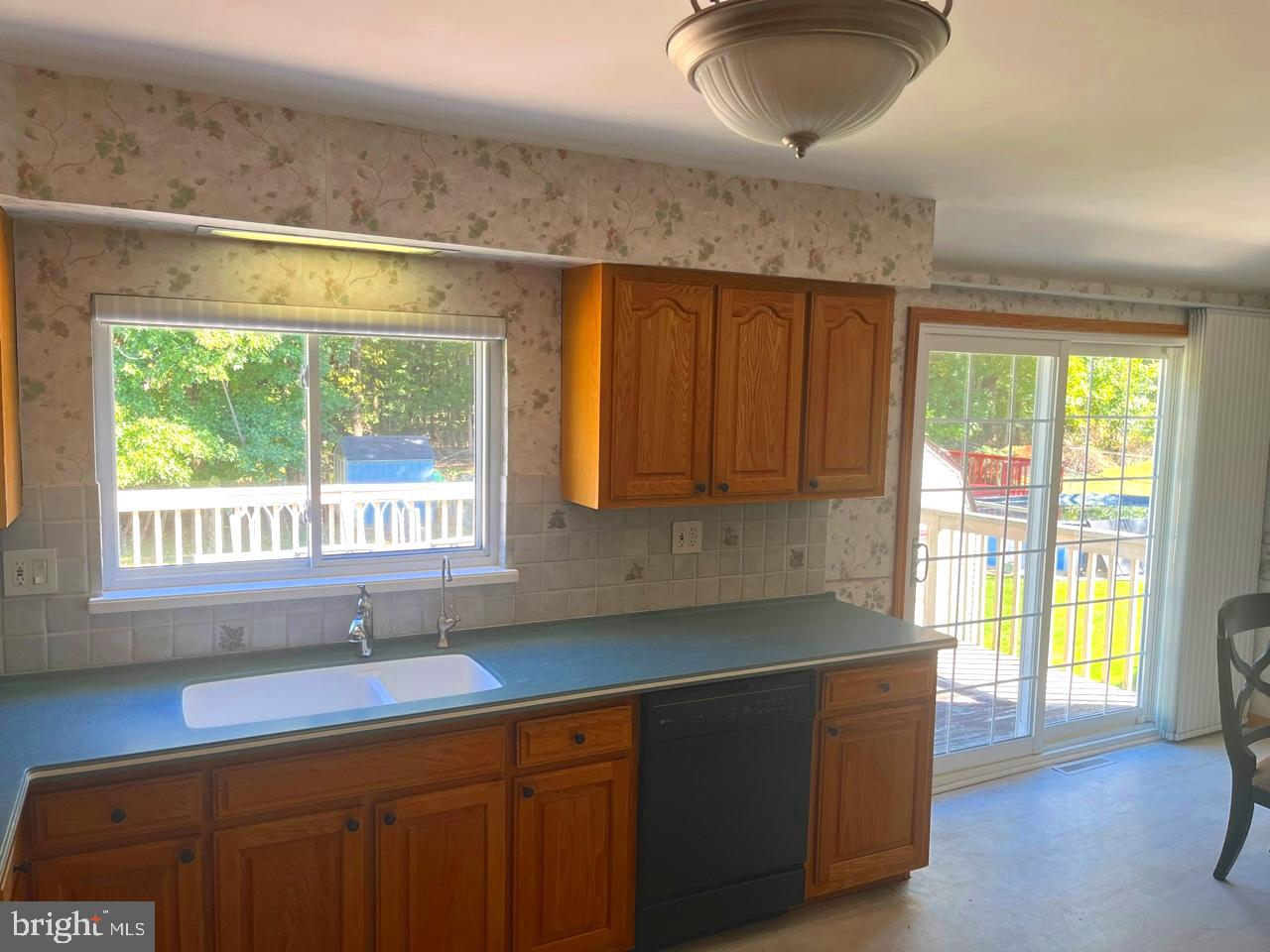 117 Knox Boulevard Marlton, NJ 08053 - Photo 7 of 21 a kitchen with wooden cabinets a sink and a window