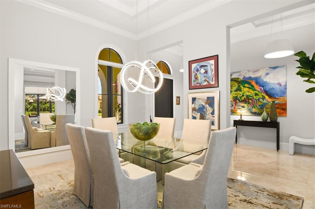 2220 Residence Circle Naples, FL 34105 - Photo 15 of 50 a dining room with furniture and wooden floor