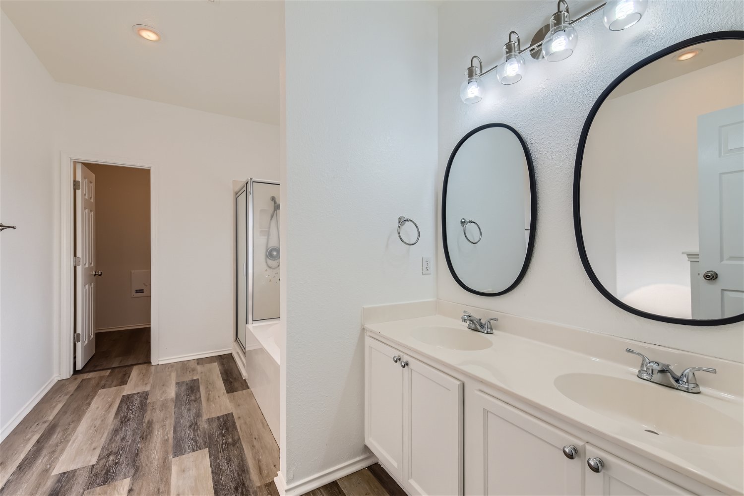 115 Killian Loop Hutto, TX 78634 - Photo 6 of 14 Dual vanity sinks provide ample space in this bright, functional primary bathroom with a separate shower and soaking tub.