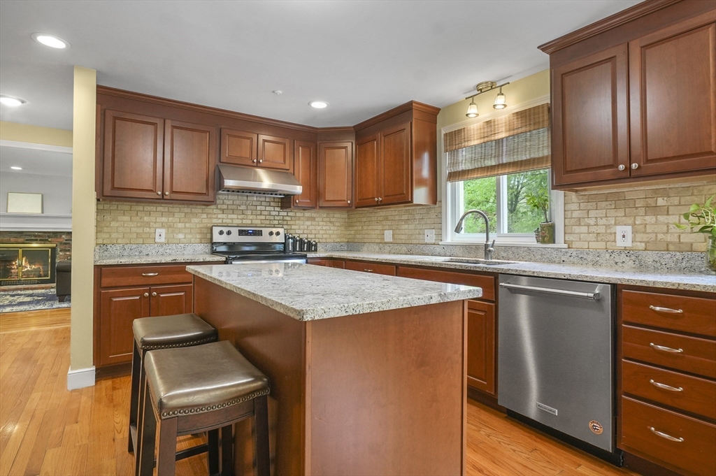 36 Duggan Road Acton, MA 01720 - Photo 11 of 40 a kitchen with stainless steel appliances granite countertop a sink stove and refrigerator