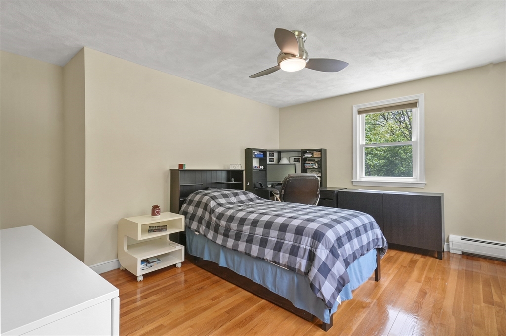 36 Duggan Road Acton, MA 01720 - Photo 23 of 40 a bedroom with a bed and wooden floor