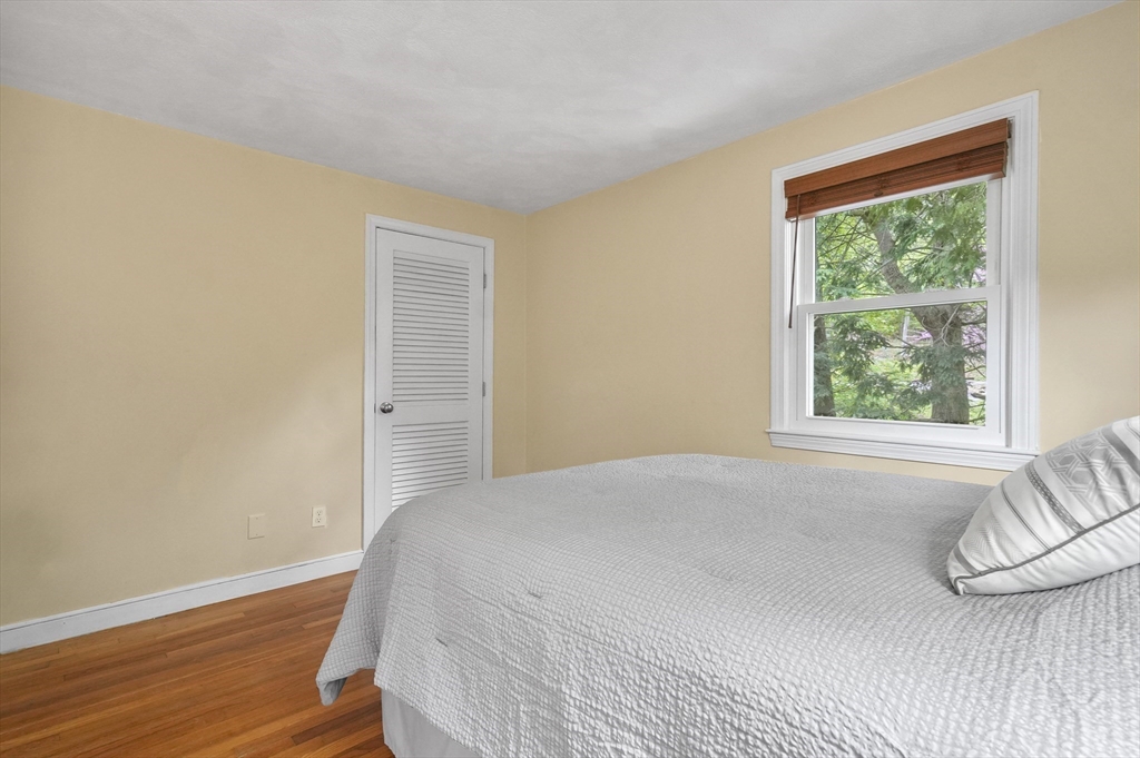 36 Duggan Road Acton, MA 01720 - Photo 25 of 40 a bedroom with a bed and wooden floor