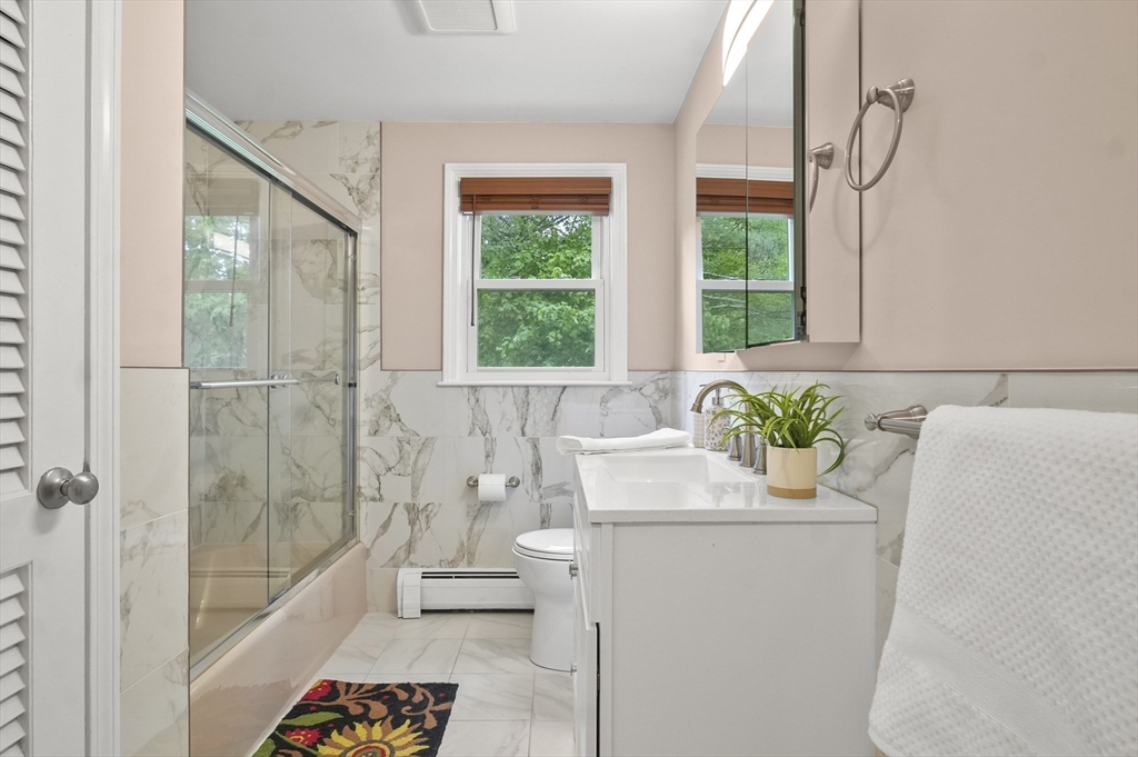 36 Duggan Road Acton, MA 01720 - Photo 27 of 40 a bathroom with a granite countertop sink a toilet and shower