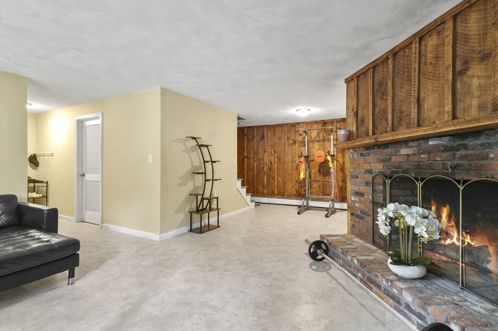 36 Duggan Road Acton, MA 01720 - Photo 29 of 40 a view of a livingroom with furniture and a fireplace
