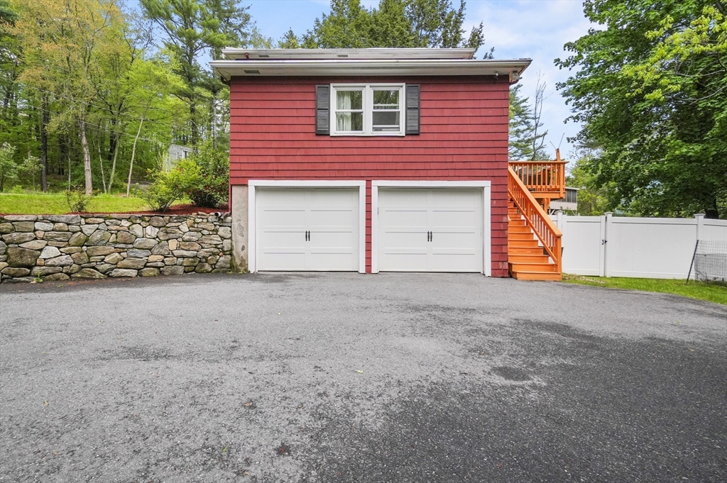 36 Duggan Road Acton, MA 01720 - Photo 37 of 40 a view of a house with a yard and garage