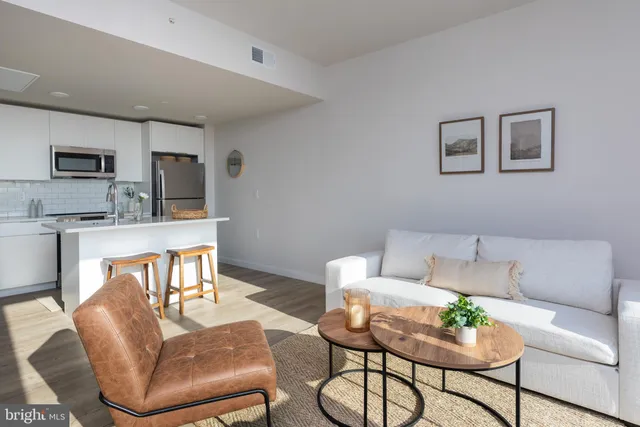 a living room with furniture and a kitchen
