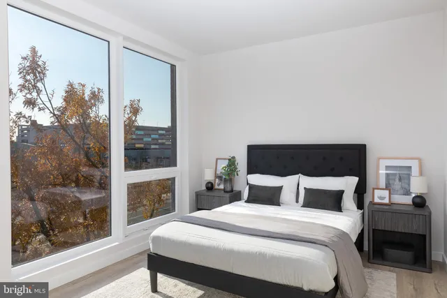 a bedroom with a bed and a mirror