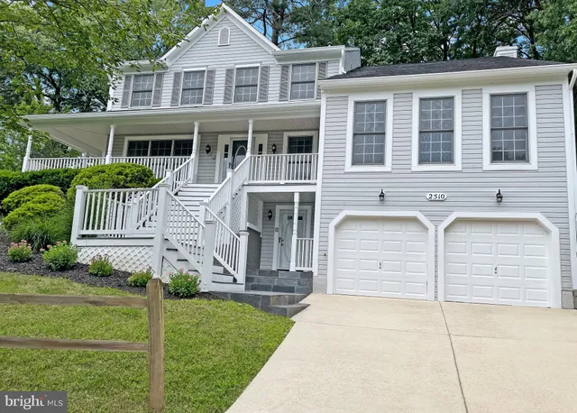 a front view of a house with a yard and fence