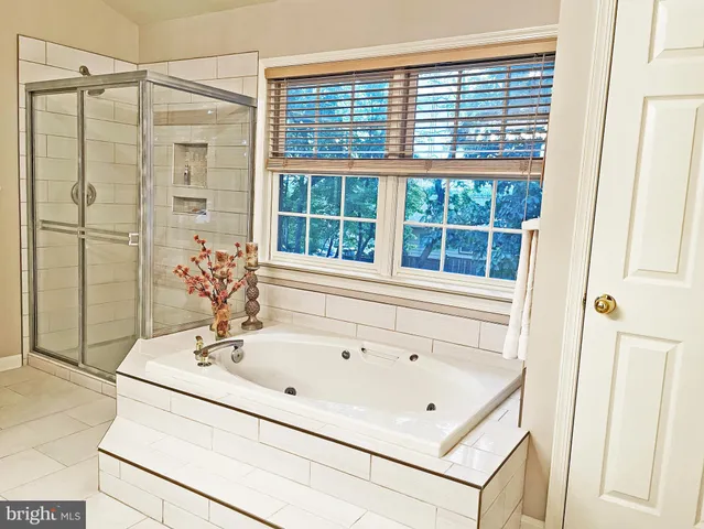 a bathroom with a tub sink and shower