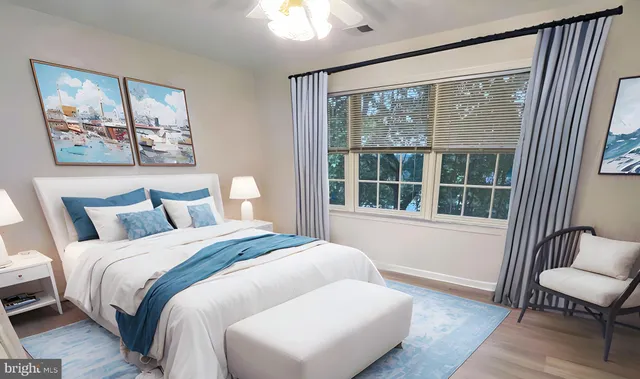 a spacious bedroom with a bed and a large window