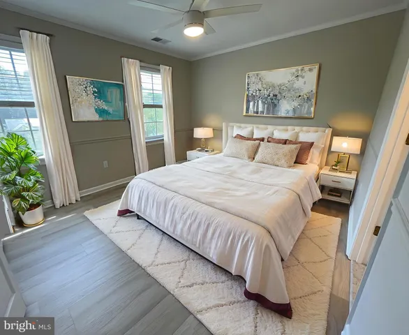 a bedroom with a large bed and a painting on the wall