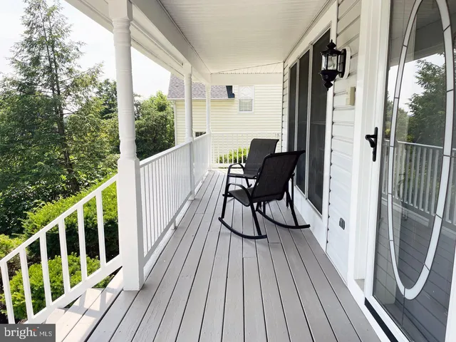a view of balcony with wooden floor and outdoor seating