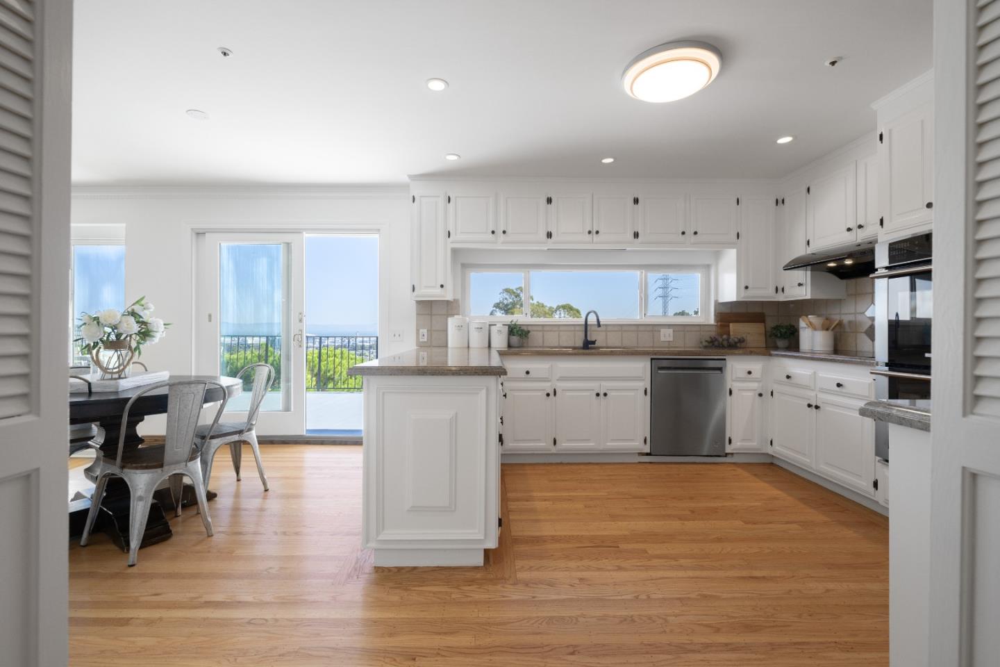 866 Morningside Drive Millbrae, CA 94030 - Photo 11 of 57 a kitchen that has a lot of cabinets in it and wooden floors
