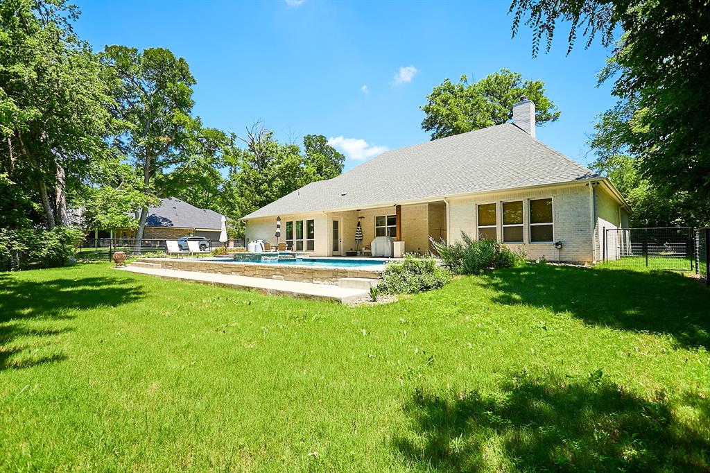 358 Glade Valley Road Azle, TX 76020 - Photo 28 of 35 Expansive backyard featuring a rectangular swimming pool, stone coping, and a surrounding patio