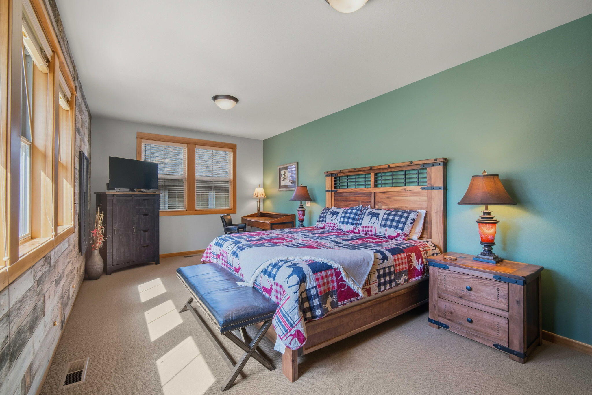 57129 Evergreen Loop, Unit 44 Sunriver, OR 97707 - Photo 27 of 59 a bedroom with a bed and large windows