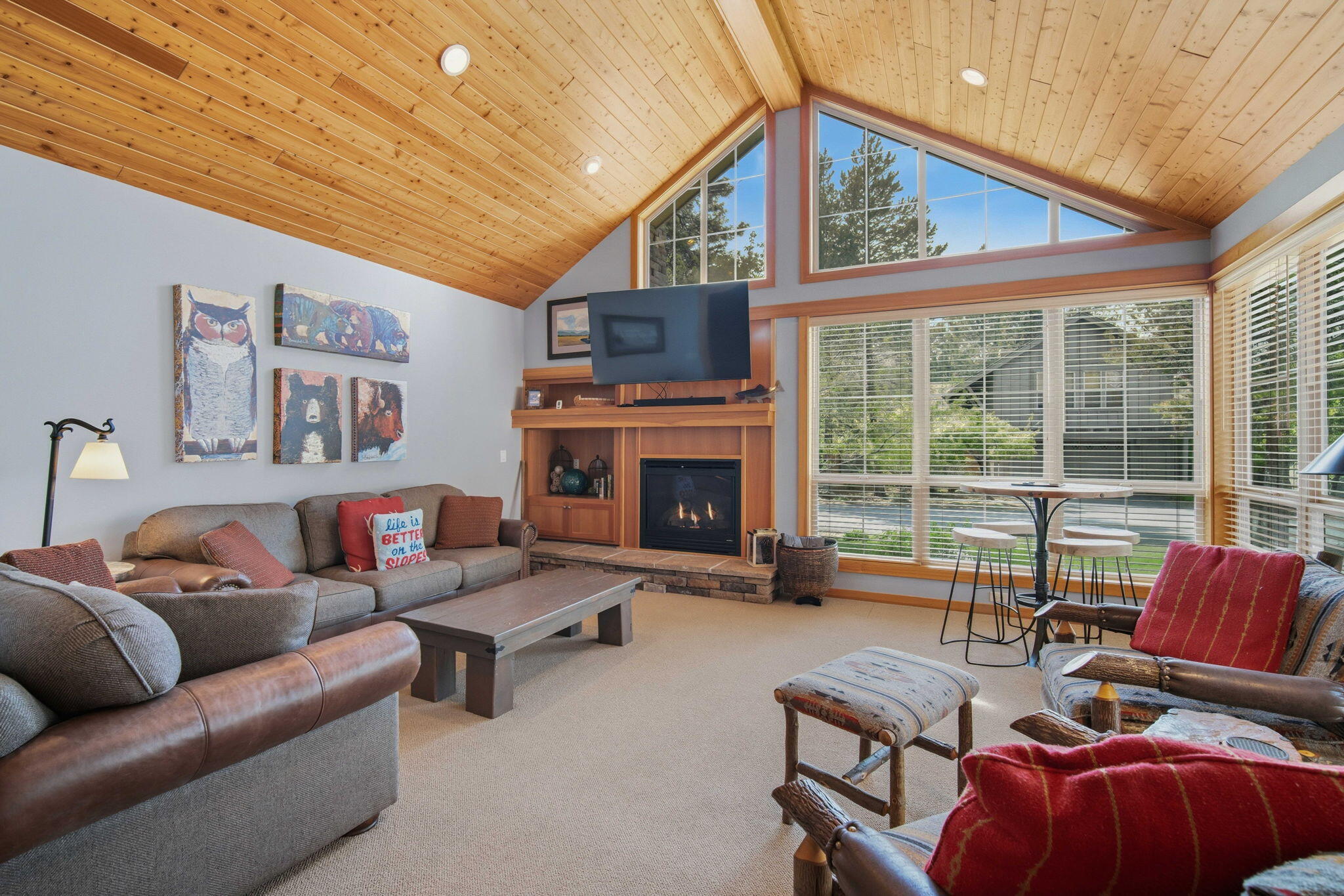57129 Evergreen Loop, Unit 44 Sunriver, OR 97707 - Photo 4 of 59 a living room with furniture a fireplace and a flat screen tv