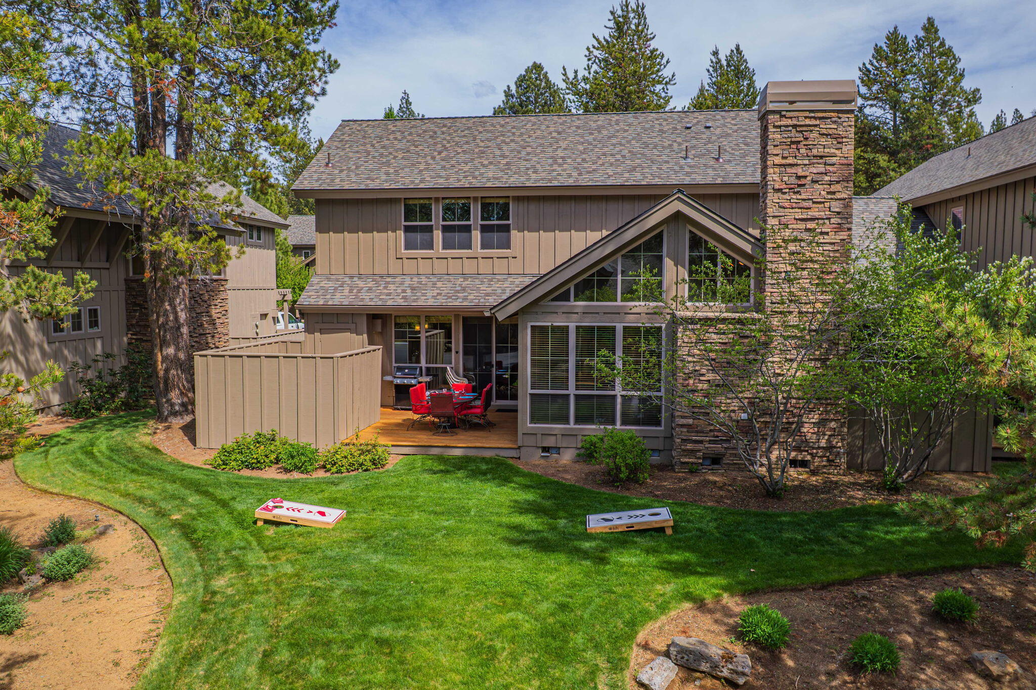 57129 Evergreen Loop, Unit 44 Sunriver, OR 97707 - Photo 54 of 59 a view of a house with a yard and sitting area