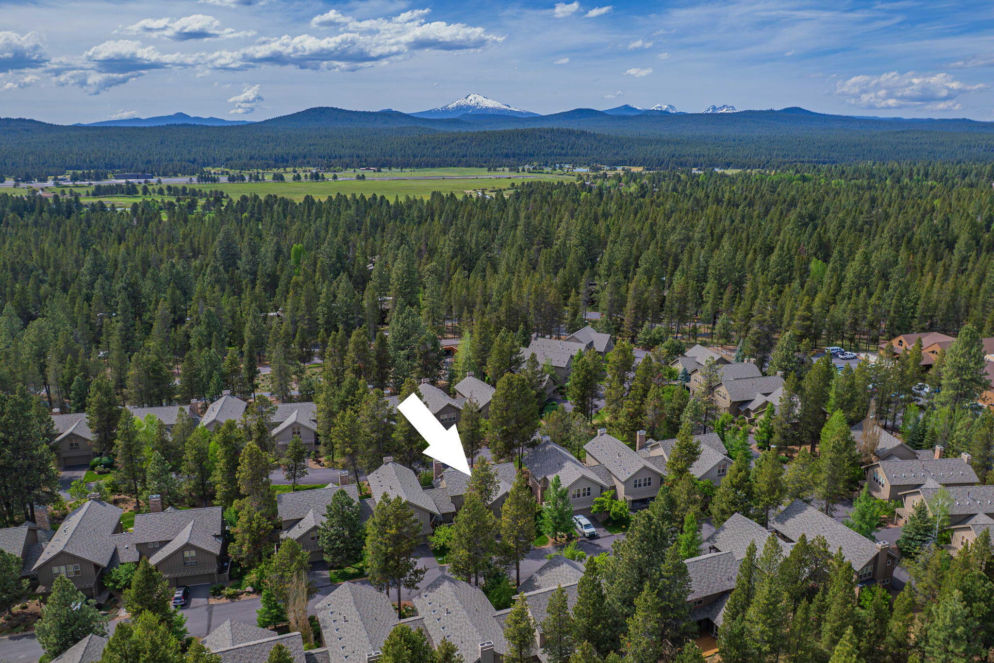 57129 Evergreen Loop, Unit 44 Sunriver, OR 97707 - Photo 55 of 59 a view of a lush green hillside and houses