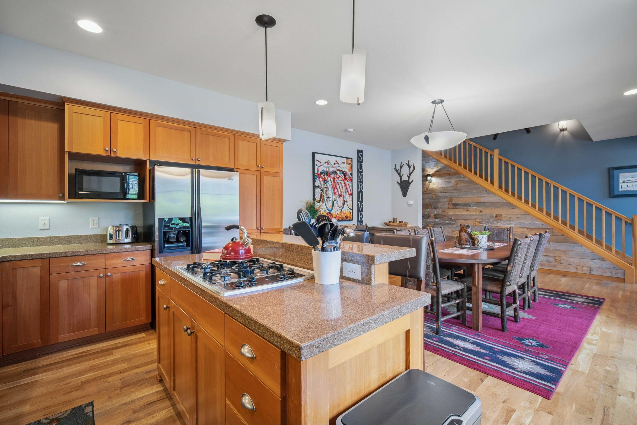 57129 Evergreen Loop, Unit 44 Sunriver, OR 97707 - Photo 8 of 59 a kitchen with stainless steel appliances kitchen island granite countertop a stove a sink and a dining table with granite countertop
