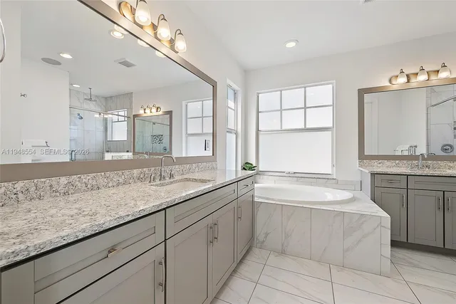 a bathroom with a granite countertop sink mirror and