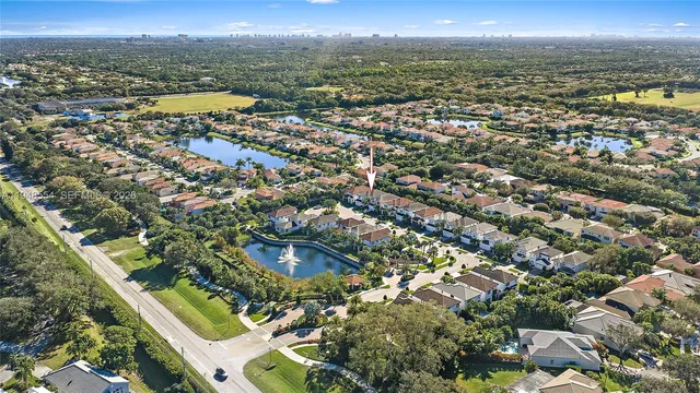 an aerial view of residential houses with outdoor space and river