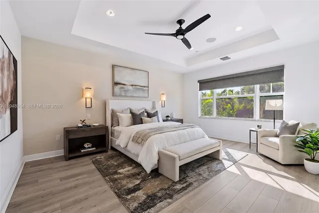 a bedroom with a large bed and a chandelier