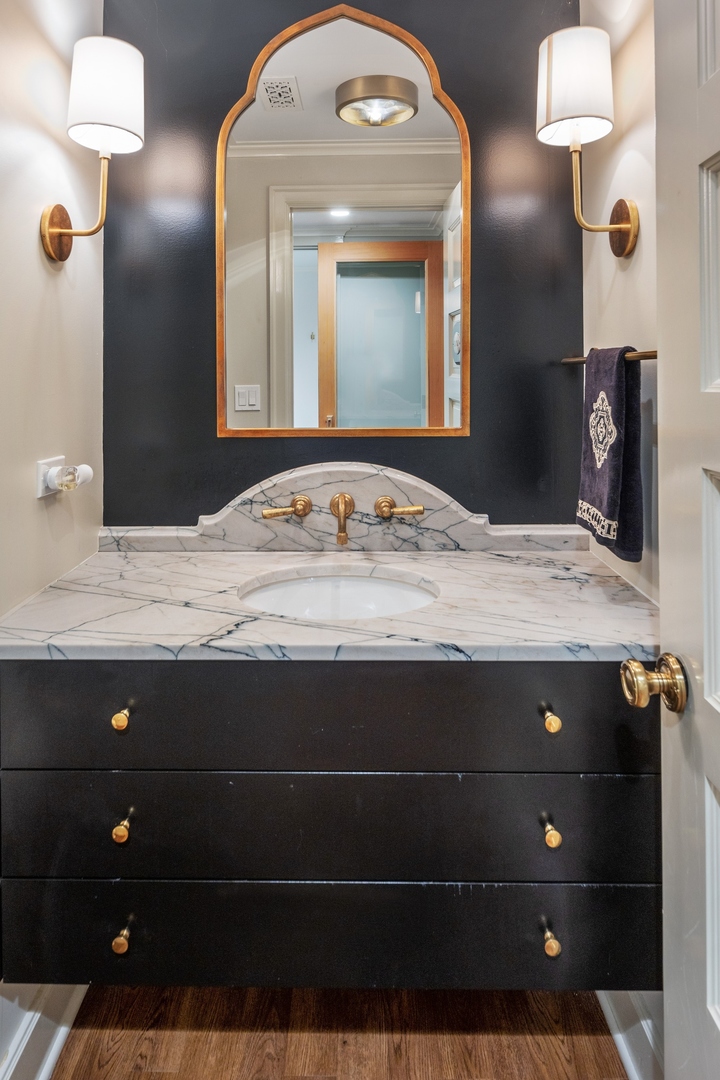 445 Sheridan Road Winnetka, IL 60093 - Photo 34 of 74 a bathroom with a sink and a mirror