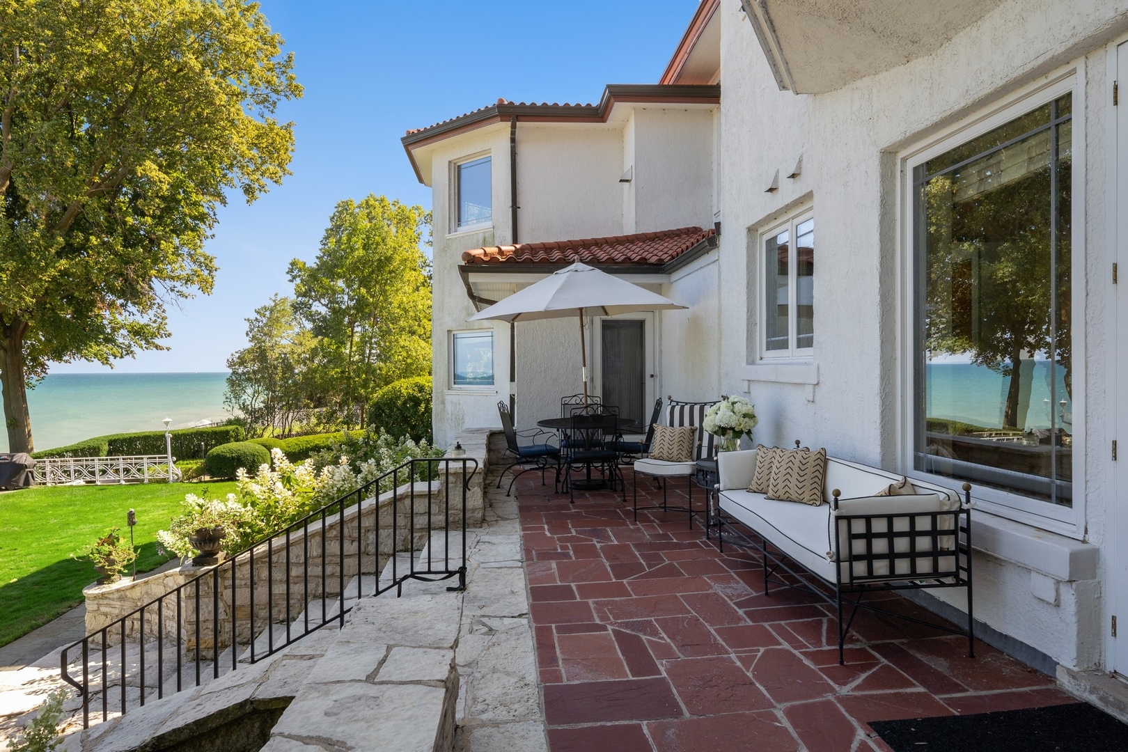 445 Sheridan Road Winnetka, IL 60093 - Photo 37 of 74 a view of a patio with couches table and chairs and potted plants