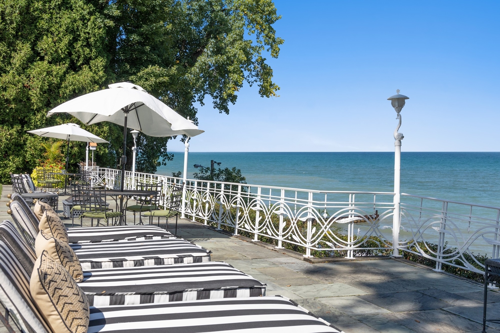 445 Sheridan Road Winnetka, IL 60093 - Photo 39 of 74 a view of a patio with a table and chairs under an umbrella