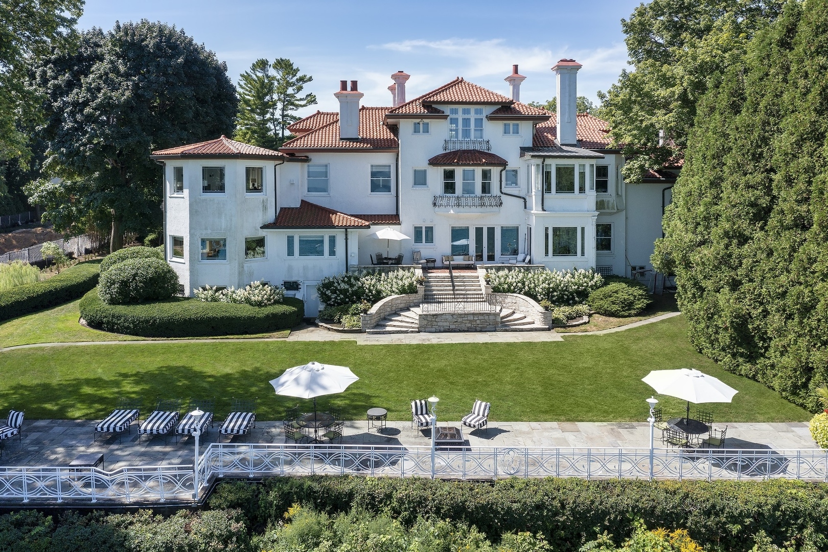 445 Sheridan Road Winnetka, IL 60093 - Photo 43 of 74 a front view of a house with a garden and patio