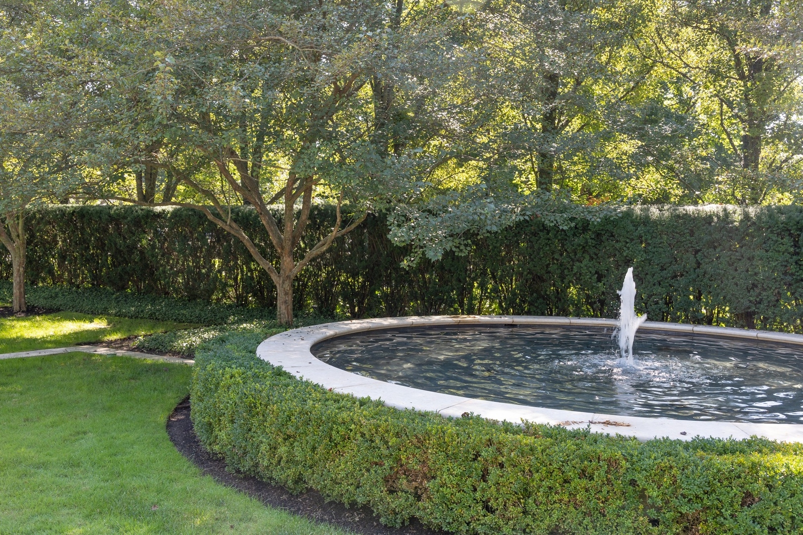 445 Sheridan Road Winnetka, IL 60093 - Photo 56 of 74 a view of a water fountain in front of a house