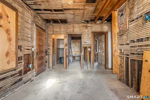a view of a hallway with wooden walls